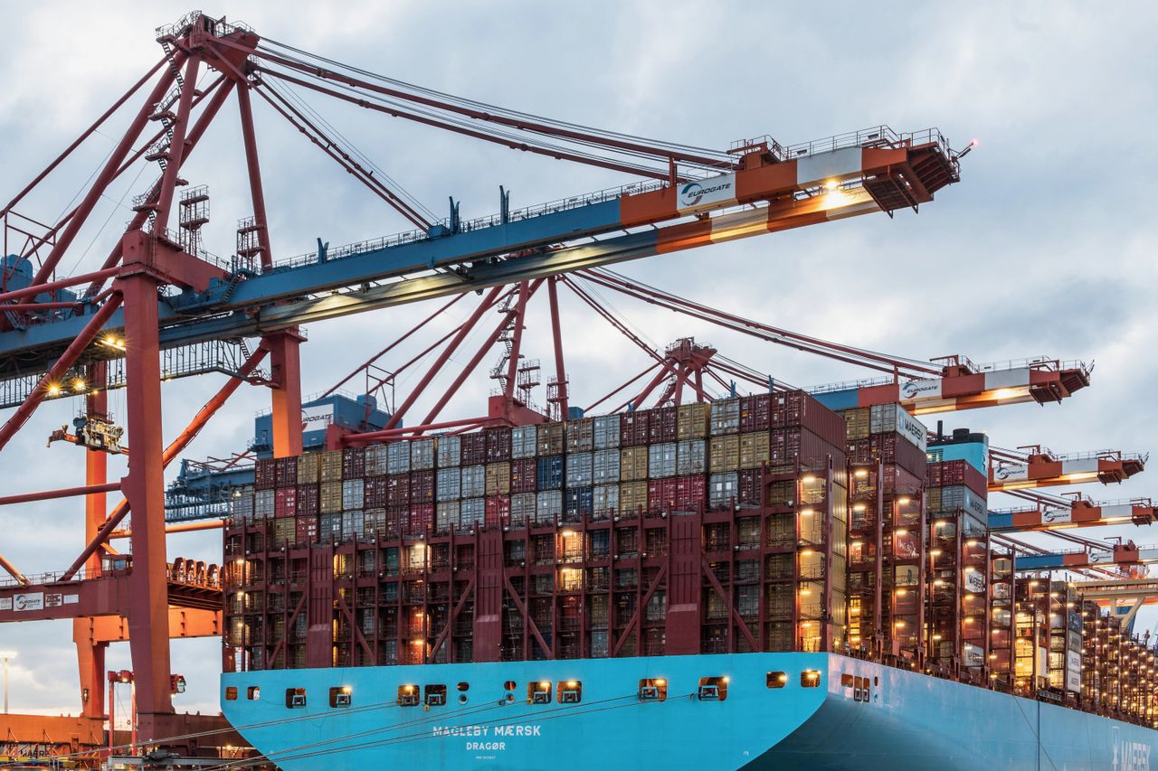 hero-img-01 A cargo ship loaded with containers at Hamburg's bustling commercial dock.
